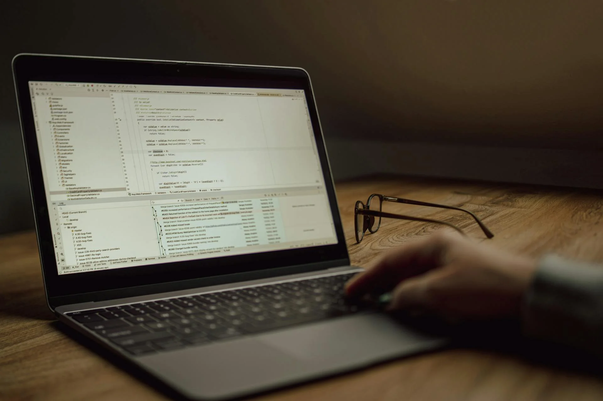 Ferramentas de criação com IA e uma base de código real partem do mesmo ponto: especificações claras — schema, papéis e regras Desenvolvedor trabalhando no laptop com código de programação